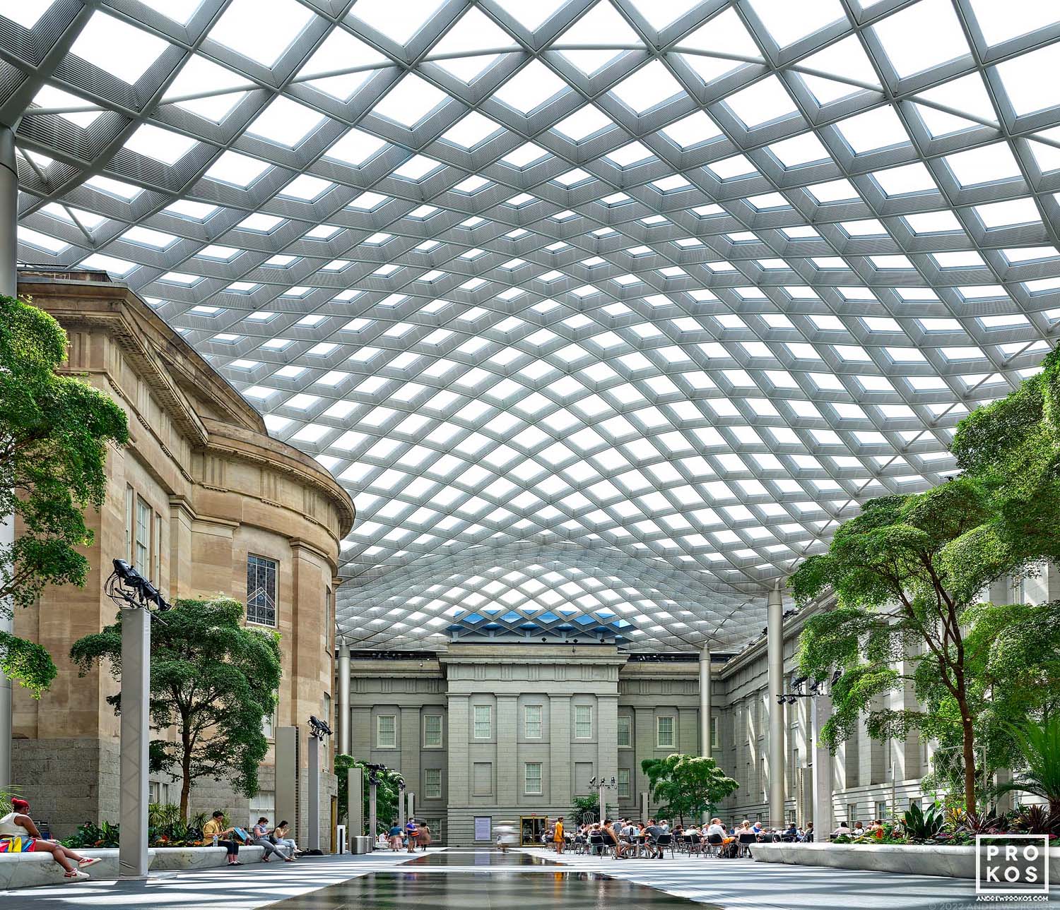 An architectural interior photo of Kogod Courtyard, with its undulating glass and steel canopy in the National Portrait Gallery, Washington DC
