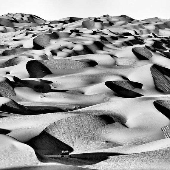 A high-resolution panoramic landscape of the high dunes of Liwa Desert, in the Arabian peninsula in black and white. Large-format black and white prints of this photo are available up to 150 inches in width.