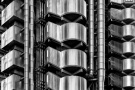 A black and white close-up view of exposed pipes, ducts, and stairwells from the iconic Lloyd's Building in London, by architect Richard Rogers. Limited edition black and white prints of this photo are available up to 72 inches in width and framed in wood, metal, and acrylic styles.