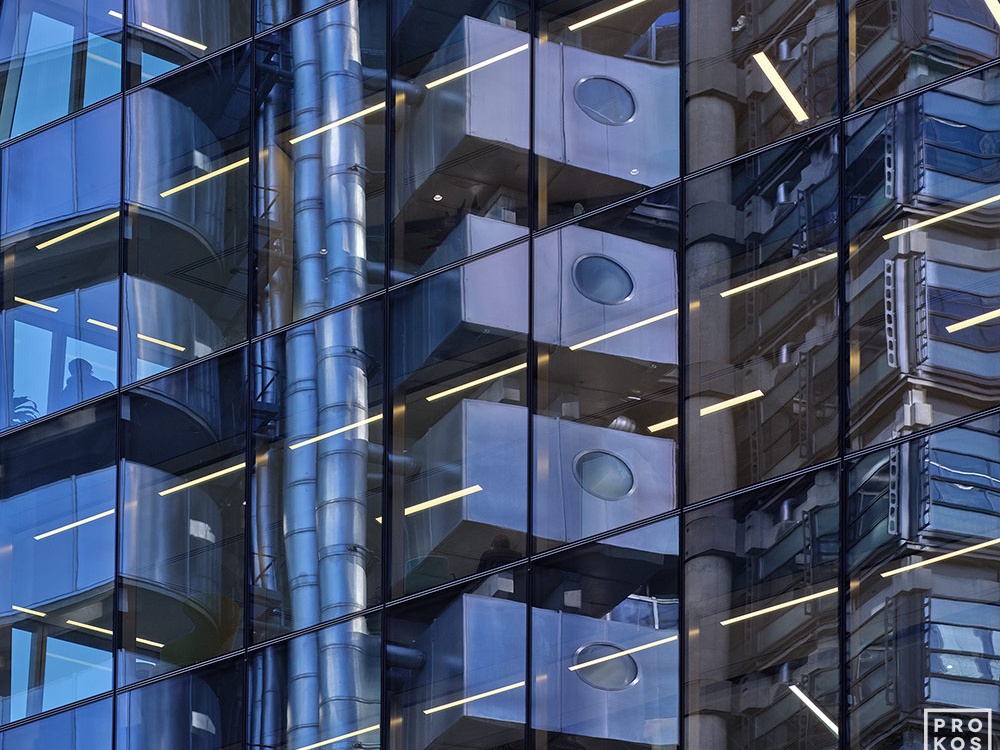 An abstract photograph of City of London building reflections on a black glass facade in tones of blue, black, and grey. Large-format limited edition prints of this photo are available up to 72 inches in width.