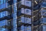 An abstract photograph of City of London building reflections on a black glass facade in tones of blue, black, and grey. Large-format limited edition prints of this photo are available up to 72 inches in width.