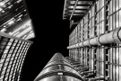 A black and white upward looking view of the Lloyd's Building and adjacent towers in the City of London, United Kingdom. Limited edition fine art prints of this photo are available up to 72 inches in height.