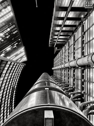 A black and white upward looking view of the Lloyd's Building and adjacent towers in the City of London, United Kingdom. Limited edition fine art prints of this photo are available up to 72 inches in height.
