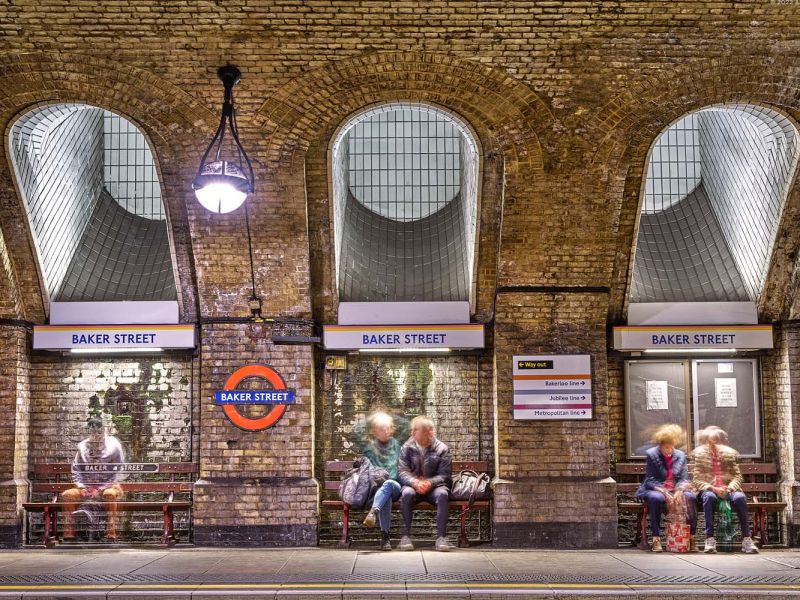 A long-exposure color fine art photo of people in the Baker Street Underground station in London, United Kingdom by photographer Andrew Prokos