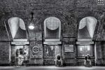 A long-exposure black and white photo of people in transit in the Baker Street Underground station in London, United Kingdom by photographer Andrew Prokos