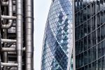 A color view of contrasting facades of towers in the City of London, including 30 St. Mary Axe (the Gherkin), the Lloyd's building, and Willis Towers. High-definition fine art prints of this photograph are available up to 72 inches in height.