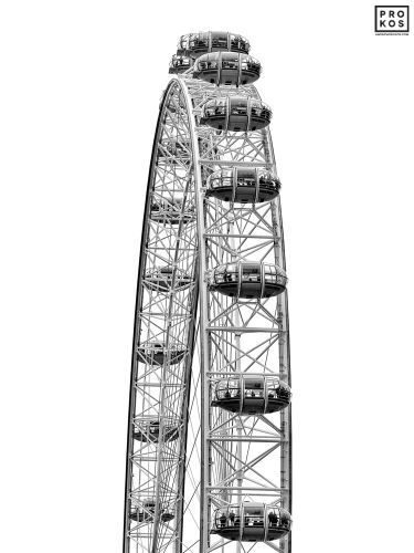 Black and white fine art photography of the London Eye Ferris wheel, United Kingdom. The upper portion of the wheel and pods are captured in detail with a high-key graphic rendition. Limited edition prints of this photo are available up to 80 inches in height.