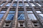 An architectural photograph of the Art Deco era Holland House Building with the adjacent Gherkin tower reflected on the facade, London, United Kingdom. Fine art prints of this photo are available up to 72 inches in width and framed in various wood, metal and acrylic styles. 