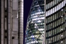 A night view of the modern towers of the City of London, including 30 St. Mary Axe (Swiss Re Building, aka the Gherkin), the Lloyd's Building, and Willis Towers. High-definition fine art prints of this photo are available up to 72 inches in height.