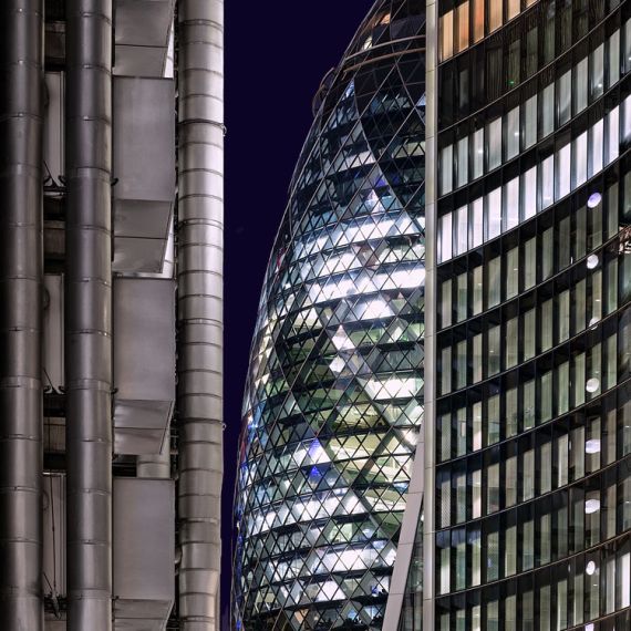 A night view of the modern towers of the City of London, including 30 St. Mary Axe (Swiss Re Building, aka the Gherkin), the Lloyd's Building, and Willis Towers. High-definition fine art prints of this photo are available up to 72 inches in height.