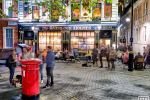 A street scene showing the Sherlock Holmes Pub at night, London, United Kingdom