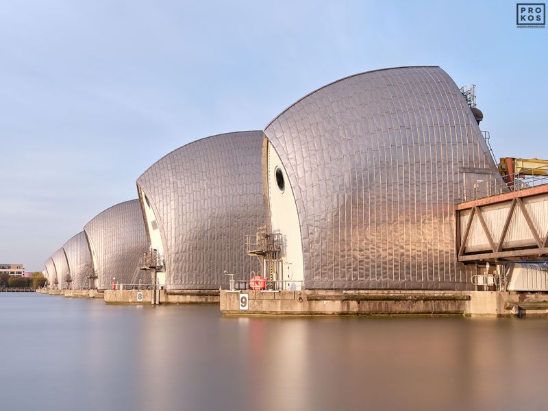 Long-exposure fine art photography of the Thames Barrier in London, United Kingdom. Captured with an eight-minute exposure time, the flowing river and sky are rendered with a soft ethereal quality. Large-format fine art prints of this photo are available up to 72 inches in width.