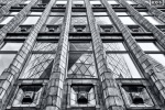 Black and white architectural photography of the Art Deco era Holland House Building with the adjacent Gherkin tower reflected on the facade, London, United Kingdom. Fine art prints of this photo are available up to 72 inches in width and framed in various wood, metal and acrylic styles.