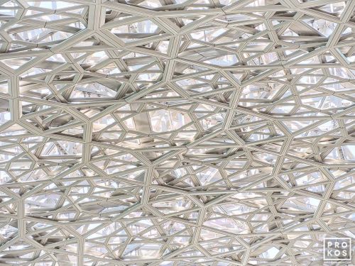 An ultra high-definition photo of the intricate geometric patterns found in the dome interior at the Louvre Museum by architect Jean Nouvel, in Abu Dhabi, United Arab Emirates.