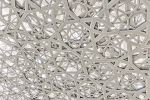 An ultra high-definition photo of the intricate geometric patterns found in the dome interior at the Louvre Museum by architect Jean Nouvel, in Abu Dhabi, United Arab Emirates.