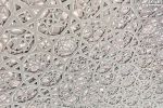 An ultra high-definition photo of the intricate geometric patterns found in the dome interior at the Louvre Museum by architect Jean Nouvel, in Abu Dhabi, United Arab Emirates.