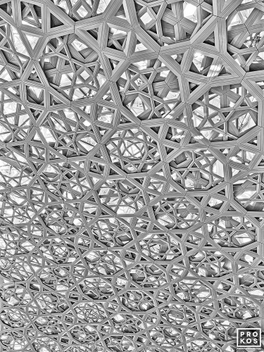 A high-definition black and white photo of the geometric patterns from the interior of the dome at the Louvre Museum in Abu Dhabi, United Arab Emirates. Large-format limited edition prints of this photo are available up to 80 inches in height and framed in contemporary styles