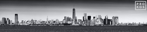 An ultra-wide panoramic skyline of New York City, the World Trade Center, the Statue of Liberty, and New York Harbor in black and white