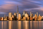 A skyline of Lower Manhattan and the World Trade Center at sunset, New York City