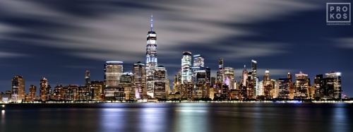 A long-exposure photo of the Lower Manhattan skyline and World Trade Center in New York City at night. Large-scale framed prints of this high-definition photo are available up to 120 inches in width. 
