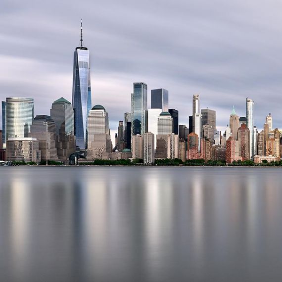 New York skyline photo of Lower Manhattan and the World Trade Center during the day. Captured with an eight minute long-exposure time by photographer Andrew Prokos