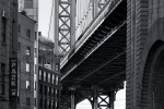A black and white photo of the Manhattan Bridge as seen from Downtown Brooklyn, New York City
