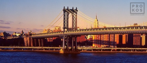 A color fine art photo of the Manhattan Bridge and East River at sunset, New York City. Fine art prints of this photo are available framed in various styles. 