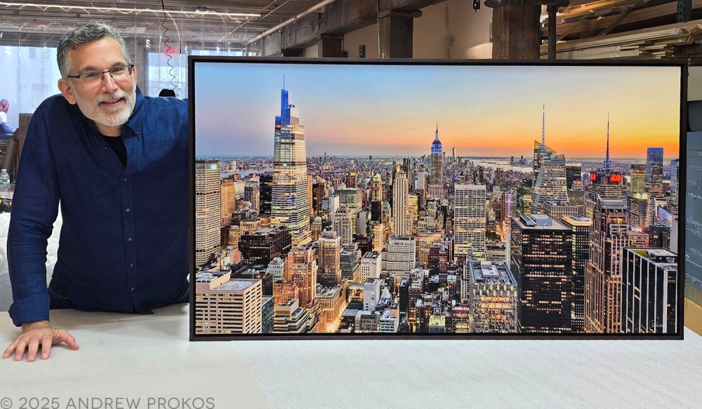 Photographer Andrew Prokos with a 50 inch framed limited edition print of Midtown Manhattan Cityscape at Dusk