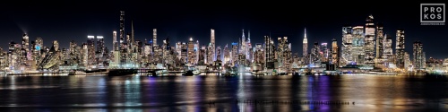 An ultra-wide panoramic view of the west side of Manhattan at night, stretching from Midtown to Hudson Yards. High-definition fine art prints of this photo are available up to 250 inches in width and framed in contemporary styles.
