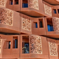 An architectural detail photo of the undulating terracotta facade of the Masdar Institute in Abu Dhabi, UAE by Foster + Partners. Limited edition fine art prints of this photo are available framed in various wood, metal, and acrylic styles. 