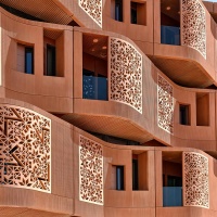 An architectural detail photo of the undulating terracotta facade of the Masdar Institute in Abu Dhabi, UAE by Foster + Partners. Limited edition fine art prints of this photo are available framed in various wood, metal, and acrylic styles. 
