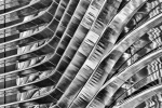 Black and white photography of curved stainless steel ribs from a contemporary architectural facade. Large-scale fine art prints of this photo are available up to 80 inches and framed in various styles.