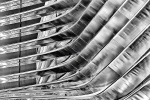Black and white architectural photography of curved stainless steel ribs from a contemporary facade. Large-scale fine art prints of this photo are available up to 80 inches and framed in various wood, metal, and acrylic styles. 