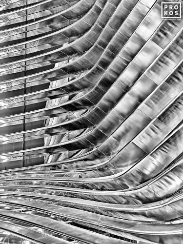 Black and white architectural photography of curved stainless steel ribs from a contemporary facade. Large-scale fine art prints of this photo are available up to 80 inches and framed in various wood, metal, and acrylic styles. 