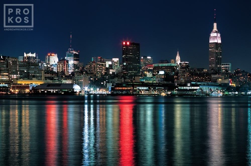 A view of the lights of Manhattan reflected on the Hudson River as seen from Hoboken, New Jersey at night