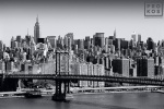 A fine art cityscape photo of the New York City skyline and the Manhattan Bridge in black and white