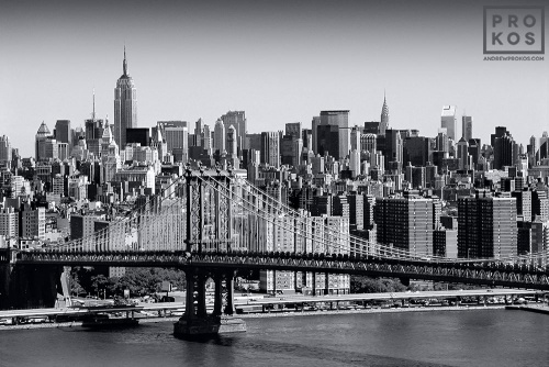 A fine art cityscape photo of the New York City skyline and the Manhattan Bridge in black and white