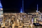 A high-definition panoramic cityscape capturing a wide angle view of Midtown Manhattan, the Empire State Building, and the Tribute in Light as seen from Rockefeller Center at night, New York City. Captured on the 20th Anniversary of September 11th on 9/11/2021. Large-format fine art prints of this photo are available up to 120 inches in width.
