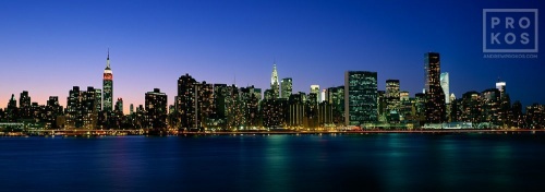 A large format panorama of the New York City skyline and East River at dusk