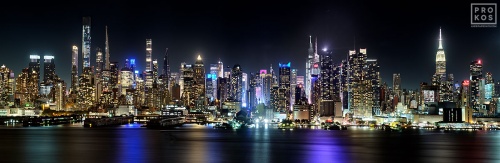 New York Skyline - A panoramic skyline of Midtown Manhattan NYC as seen from Weehawken, New Jersey at night. Large-format prints of this photo are available up to 120 inches in width.