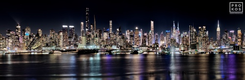 A high-definition panoramic skyline of the west side of Midtown Manhattan at night stretching from Via57 to the Empire State Building. Large-format fine art prints of this photo are available up to 250 inches in width and framed in contemporary styles.