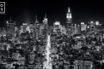 A long-exposure black and white cityscape of the buildings of Midtown Manhattan and the Empire State Building at night.  Large-scale fine art prints of this ultra high-definition photo are available up to 120 inches wide.