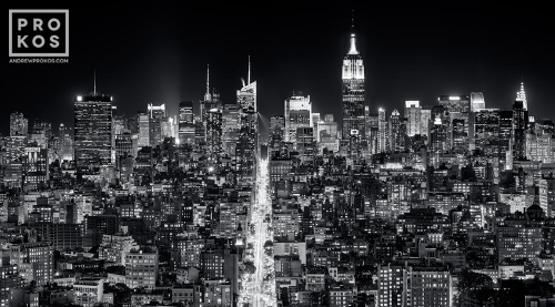 A long-exposure black and white cityscape of the buildings of Midtown Manhattan and the Empire State Building at night.  Large-scale fine art prints of this ultra high-definition photo are available up to 120 inches wide.