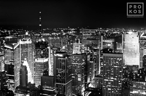 A black and white view of the skyscrapers of Midtown Manhattan at night, New York City. Fine art prints of this photo are available framed in various styles. 