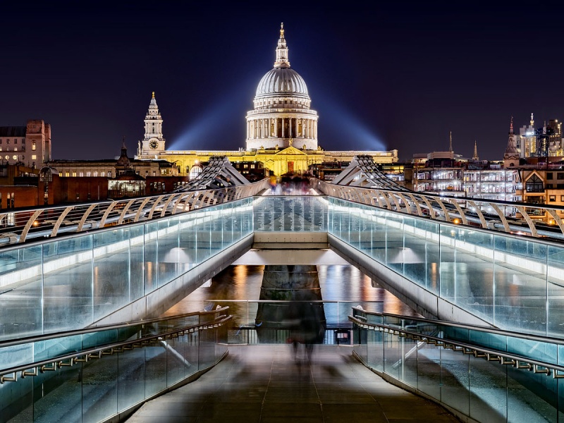 A view of the Millennium Bridge and St. Paul's Cathedral as seen at night, London, United Kingdom. Limited edition fine art prints are available up to 72 inches in width and framed in various wood, metal, and acrylic styles.