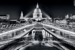 A dramatic night view of London's Millennium Bridge in black and white by photographer Andrew Prokos. High-definition limited edition prints of this photo are available up to 80 inches in width.