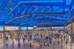 An elevated interior view of Moynihan Train Hall / Farley Building in Manhattan, New York City as seen at night. Captured by architectural photographer Andrew Prokos for Vornado Realty Trust. The renovation architect is Skidmore, Owings & Merrill (SOM). Fine art prints are available framed in various styles.