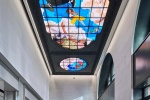 A view of the 33rd Street entrance of Moynihan Train Hall / Farley Building in Manhattan, New York City with the stained glass triptych "Go" by Kehinde Wiley. Captured by architectural photographer Andrew Prokos for Vornado Realty Trust. The renovation architect is Skidmore, Owings & Merrill (SOM). Fine art prints are available framed in wood, metal and acrylic styles.