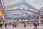 An interior view of Moynihan Train Hall in Manhattan, New York City as seen during the day. Captured by by architectural photographer Andrew Prokos for The Penn District / Vornado Realty Trust. Fine art prints are available framed in wood, metal and acrylic styles.