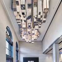 A view of the 31st Street entrance of Moynihan Train Hall / Farley Building in Manhattan, New York City with "The Hive" sculpture by artists Elmgreen & Dragset. Captured by architectural photographer Andrew Prokos for Vornado Realty Trust. The renovation architect is Skidmore, Owings & Merrill (SOM). Fine art prints are available framed in wood, metal and acrylic styles.